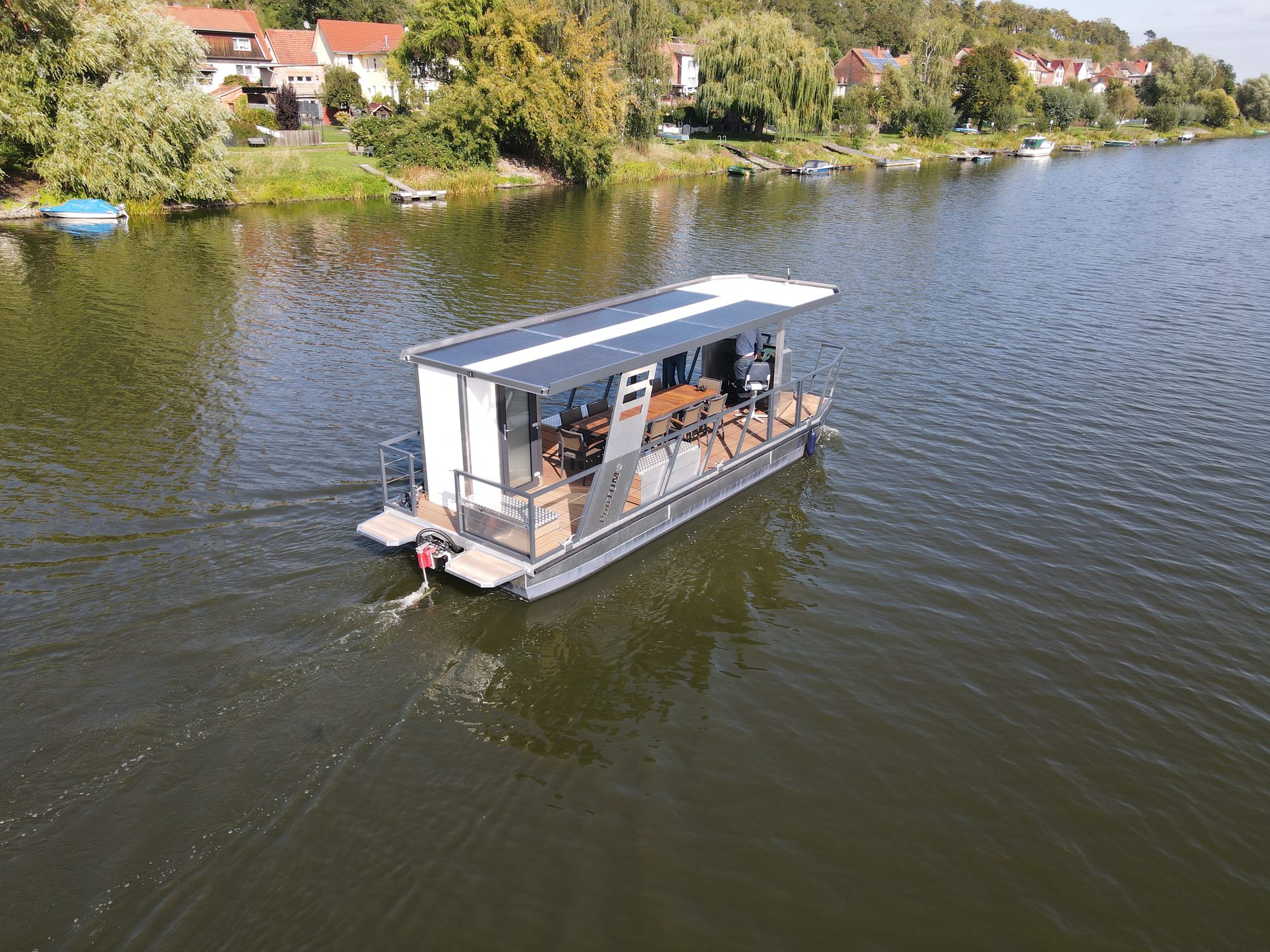 Luftbild des PonTOM-Solarboots auf der Havel vor dem Ufer von Havelberg